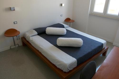a bedroom with a bed with two pillows on it at Casa Maria in Salerno