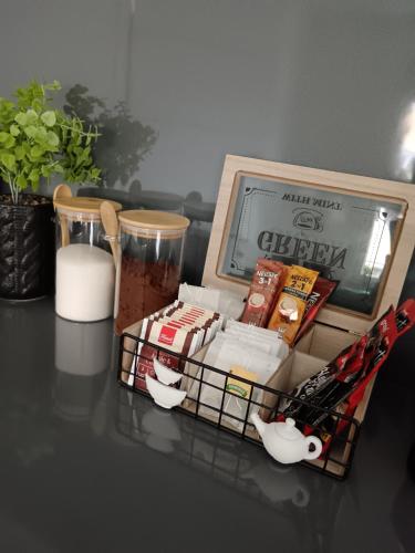 a table with a box of food on a table at SPA APARTMAN "SaUna" in Prijedor