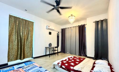 a bedroom with a bed and a ceiling fan at Home Vacays - B1SM1LLAH in Batu Arang