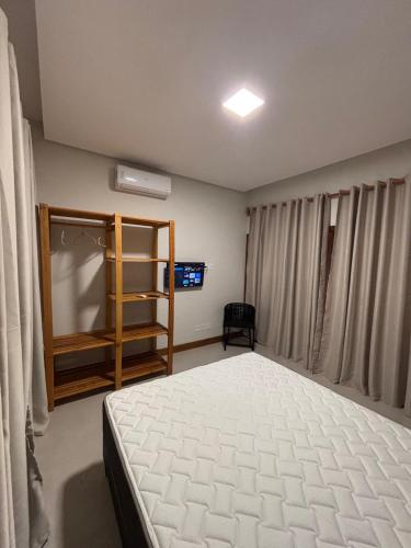 a bedroom with a large bed and a window at casa refugio das bromelhas in Itacaré