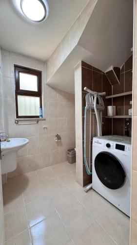a bathroom with a washing machine and a sink at Dalyan Turaman private pool sleeps 10 in Ortaca