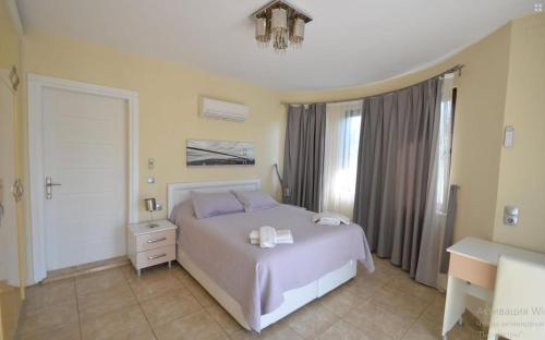 a bedroom with a white bed and a window at Dalyan Turaman private pool sleeps 10 in Ortaca