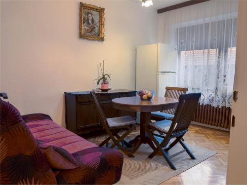 a living room with a table and chairs and a kitchen at Apartment Bistrik mahala in Sarajevo