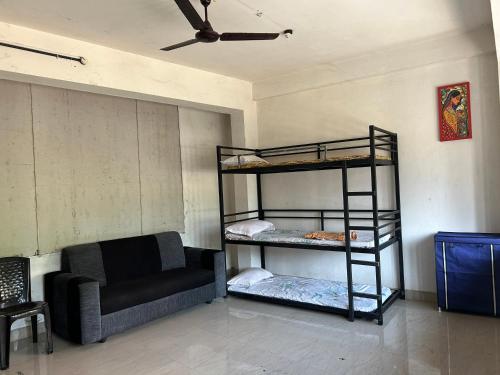 a living room with a bunk bed and a couch at Sabari Rooms in Erumeli