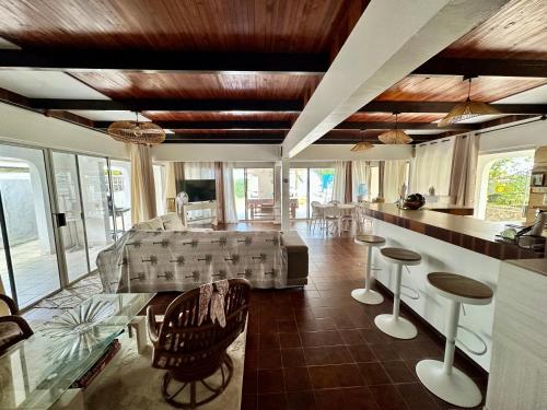 een woonkamer met een bank en een tafel bij Okilei House in Taputapuapea