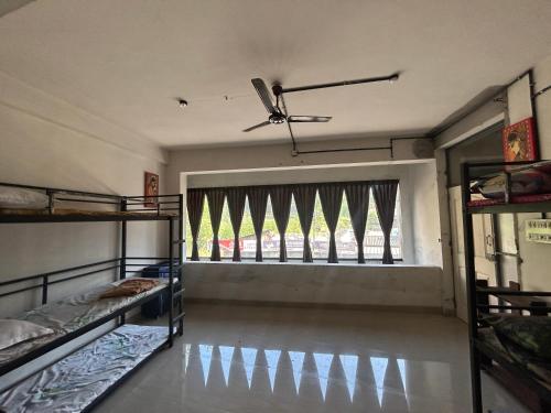 a room with two bunk beds and a window at Sabari Rooms in Erumeli