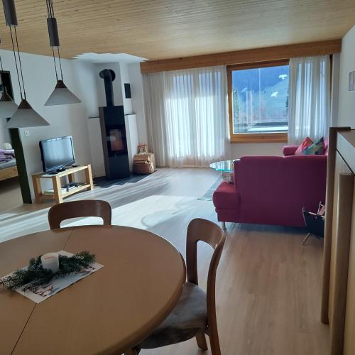 a living room with a table and a couch at Ferienwohnung Halden in Unterwasser