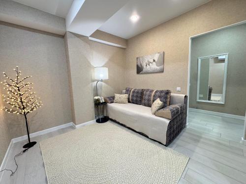 a living room with a couch and a mirror at RentNow Large and Cozy Apartment in the Center, Parking in Chişinău