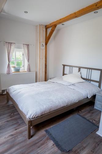 a bedroom with a large bed with a wooden frame at Jizerská roubenka in Bohdalovice