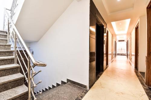 a corridor of a building with stairs at Capital O Maurya Inn in Banār