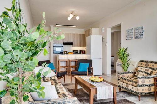 a living room with two chairs and a coffee table at Makenzy Sandy Beachfront Paradise in Larnaca