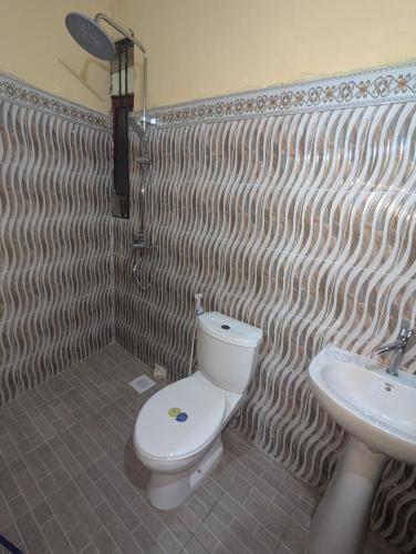 a bathroom with a toilet and a sink at Hamza Hostel in Zanzibar City