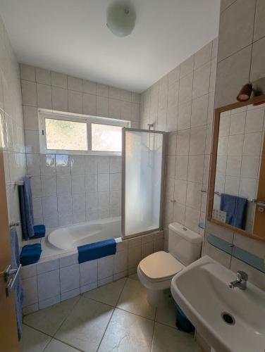 a bathroom with a toilet and a tub and a sink at Vista Oceano - Boa Vista Island in Sal Rei