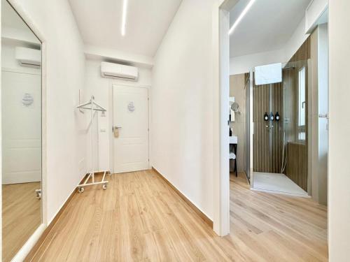 an empty room with white walls and wooden floors at Maison Plancina in Rome
