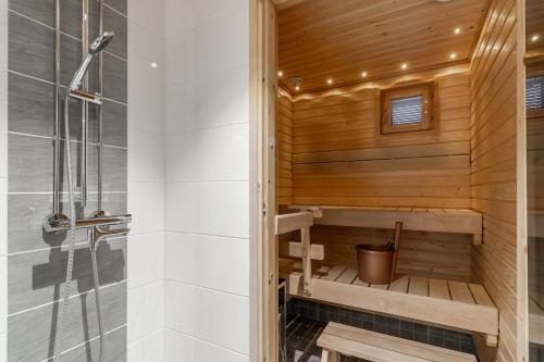 a bathroom with a sauna and a shower at Scandi Forest Flat Across from the Train Station in Rovaniemi