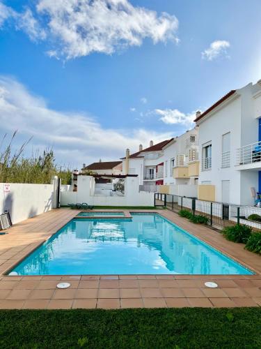 a swimming pool in the backyard of a house at Casas do Mar - Baleal 1 - Sea House in Baleal