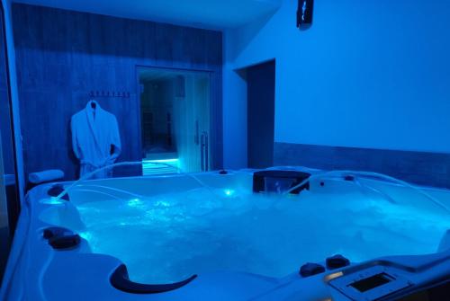 a bath tub with a man in a suit in a room at Hôtel & Spa La Villa in Sainte-Maxime