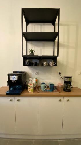 a kitchen counter with a coffee maker and a toaster at Koralia - Coliving Hotel - Gare de Niort in Niort