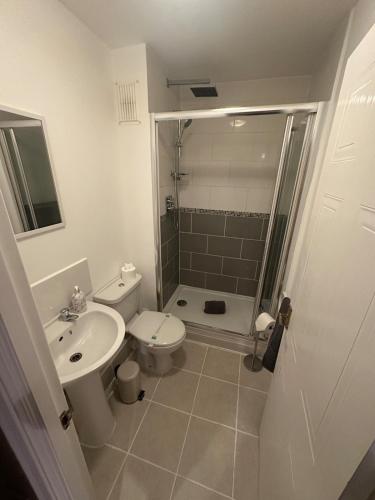a bathroom with a sink and a toilet and a shower at A Home From Home in Crawley