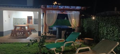 a backyard with a gazebo and chairs and a table at Casa do Faial da Terra in Faial da Terra