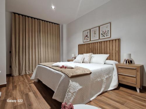 ein Schlafzimmer mit einem großen Bett und einem Nachttisch in der Unterkunft La Casita de Val in Valdelacalzada