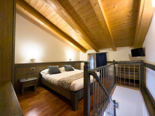 a bedroom with a bed and a balcony at IL Postale in Castel di Sangro