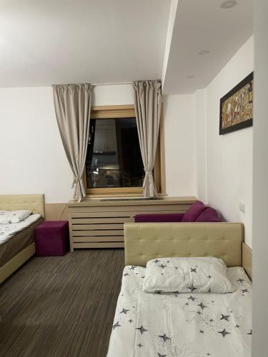 a hotel room with a bed and a window at Angela 103 in Kopaonik