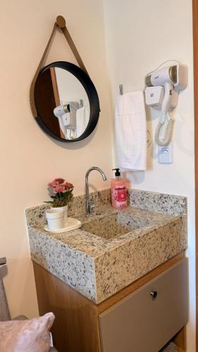 a bathroom counter with a sink and a mirror at Beira Mar - Melhor Localização Bessa Five in João Pessoa