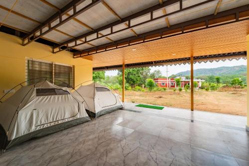 ein Zelt in einem Zimmer mit Blick auf ein Feld in der Unterkunft Dandeli Tiger Cottages in Dandeli