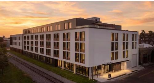 a large white building with a sunset in the background at Modern Tampa Studio Near Ybor City & Downtown in Tampa