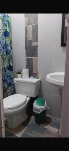 a bathroom with a toilet and a sink at Hostal Salento Sunset in Salento