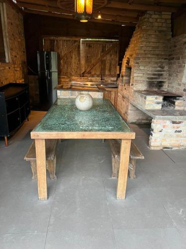 a wooden table with a vase sitting on top of it at Chalé da Joaquina in Florianópolis