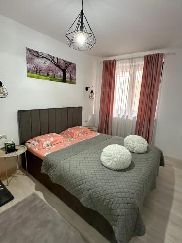 a bedroom with a bed with two pillows on it at White Studio in Câmpulung Moldovenesc