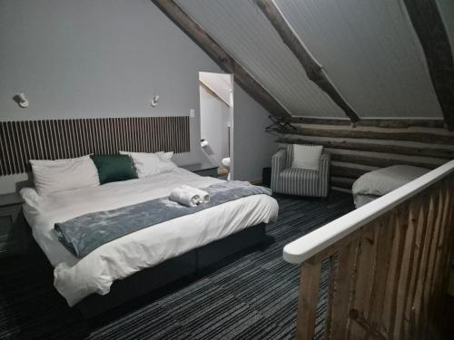 a white dog laying on a bed in a bedroom at Villa Keys in Wilderness