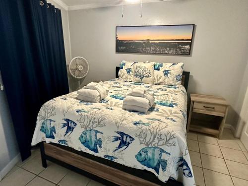 a bedroom with a bed with a blue and white comforter at Seaside 249 in Hilton Head Island