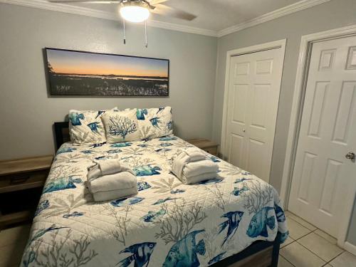 a bedroom with a bed with a blue and white comforter at Seaside 249 in Hilton Head Island