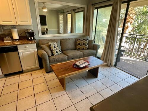 a living room with a couch and a coffee table at Seaside 249 in Hilton Head Island