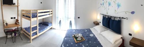 a bedroom with a bed and a bunk bed at B&B Honey Rooms in Saronno