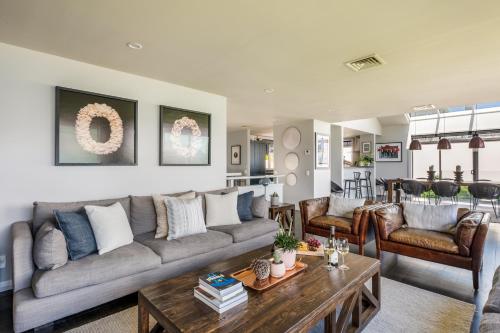 a living room with a couch and a table at Limerick- Fire Place- Lake Views- BBQ- AC in Queenstown