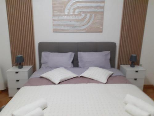 una camera da letto con un letto grande con due comodini di Vale a Županja