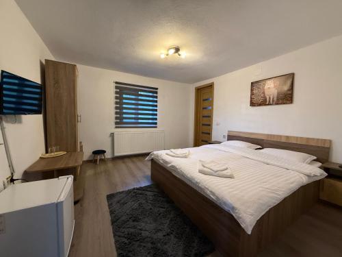 Giường trong phòng chung tại Casa Lupilor Transfăgărășan