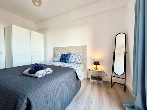 a bedroom with a bed and a mirror at Santa Luzia Resident sea view in Funchal