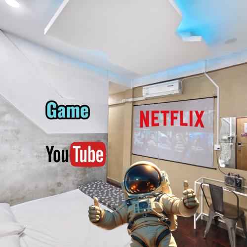 a man in an astronaut suit giving a thumbs up in a room at Hive28 in Bang Kapi