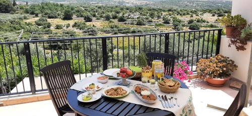 a table with food and drinks on top of a balcony at Alabianca in Villa Vela