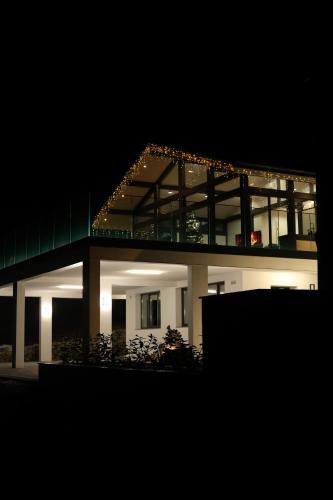 a large building with lights on it at night at Berryhouse in Vyshkiv