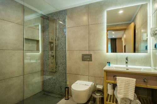 a bathroom with a toilet and a shower and a sink at Perast Garden Hotel in Cıralı
