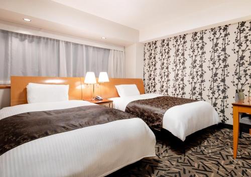En eller flere senge i et værelse på APA Hotel Kanazawa Katamachi EXCELLENT