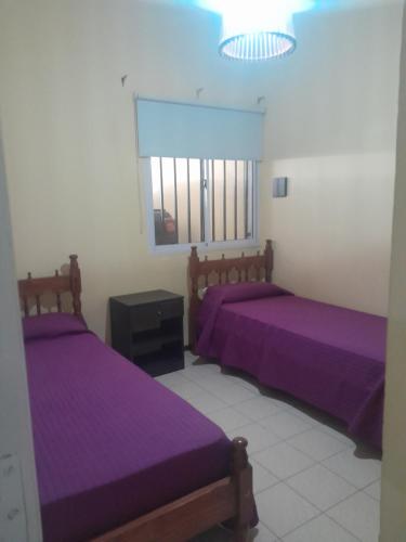 En eller flere senge i et værelse på Casa centrica turistica