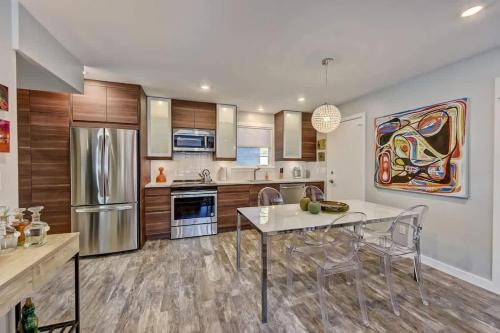 a kitchen with a table and chairs and a refrigerator at Spacious condo with easy access to Uptown in Charlotte