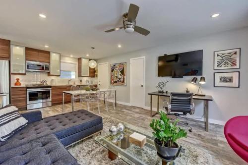 a living room with a blue couch and a kitchen at Spacious condo with easy access to Uptown in Charlotte